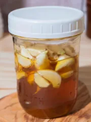 mason jar of honey and garlic with a white plastic lid