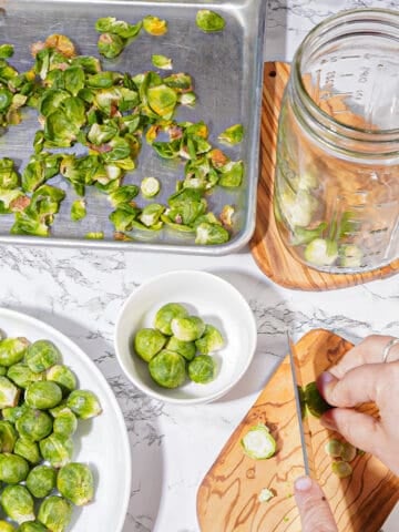 person slicing brussel sprouts