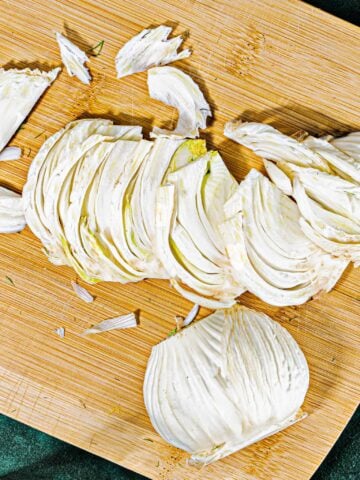 slices of fennel bulb on a wooding cutting board