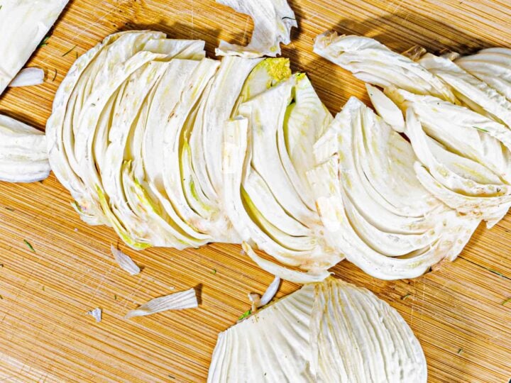 slices of fennel bulb on a wooding cutting board
