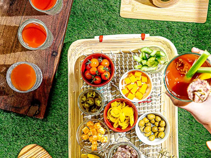 person enjoying a bloody Mary at a picnic with build your own bar picnic