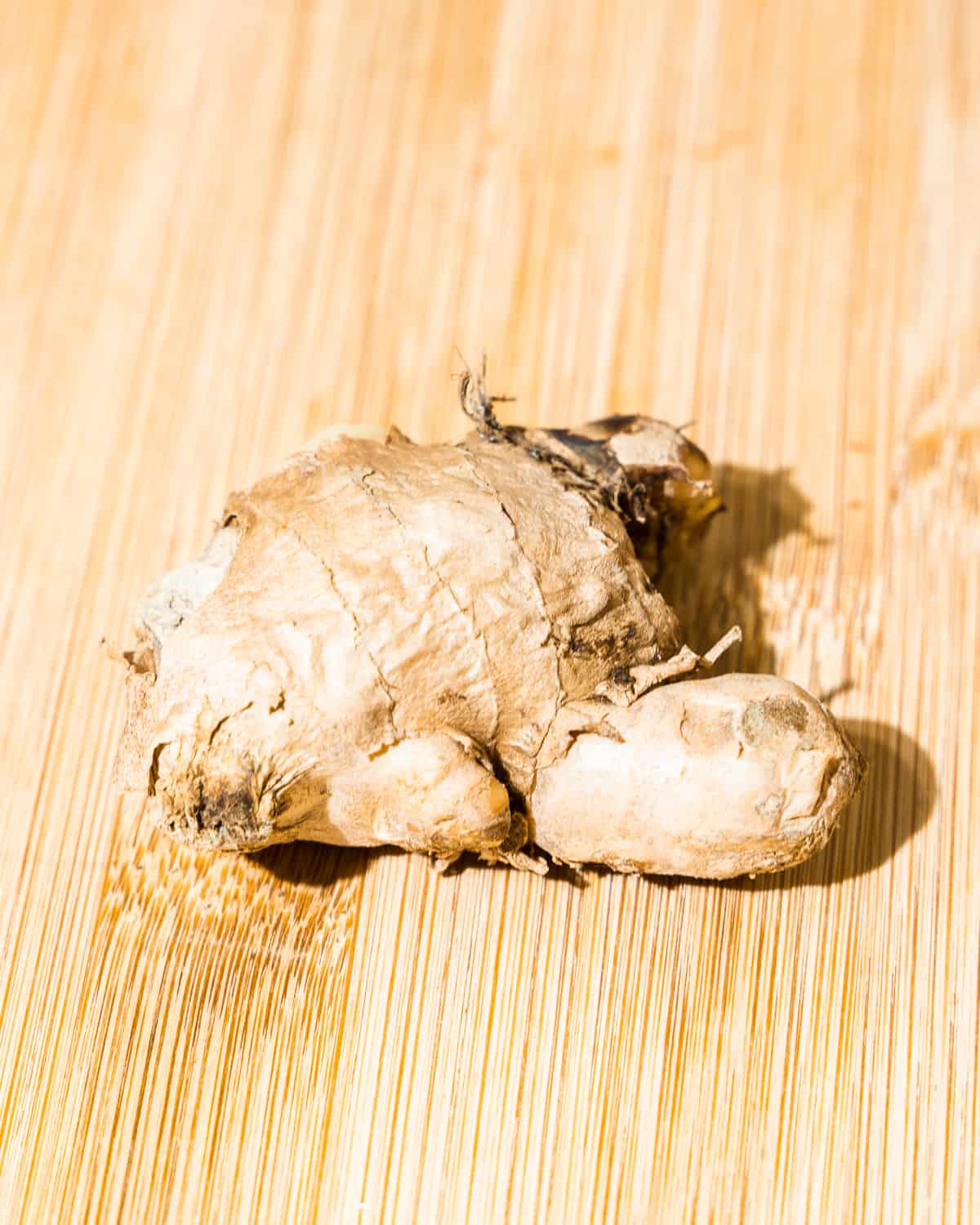 knob of ginger on a wooden background
