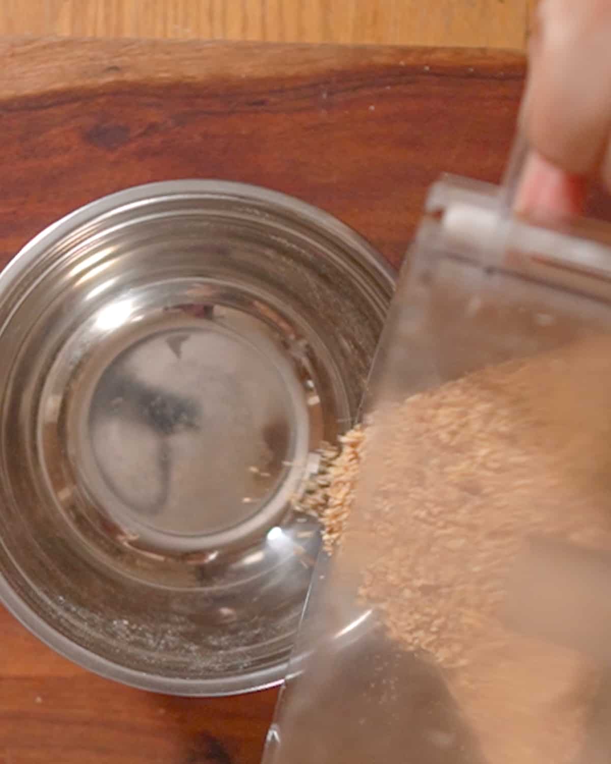 person adding almond meal to bowl