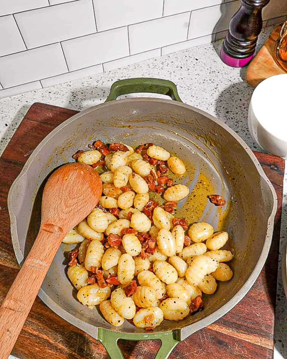 crispy pancetta and gnocchi in green pan