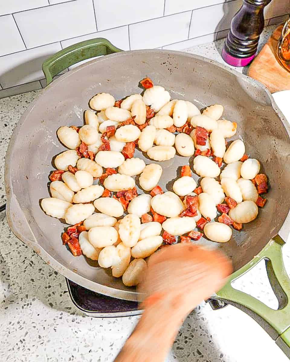 crispy pancetta and gnocchi in green pan