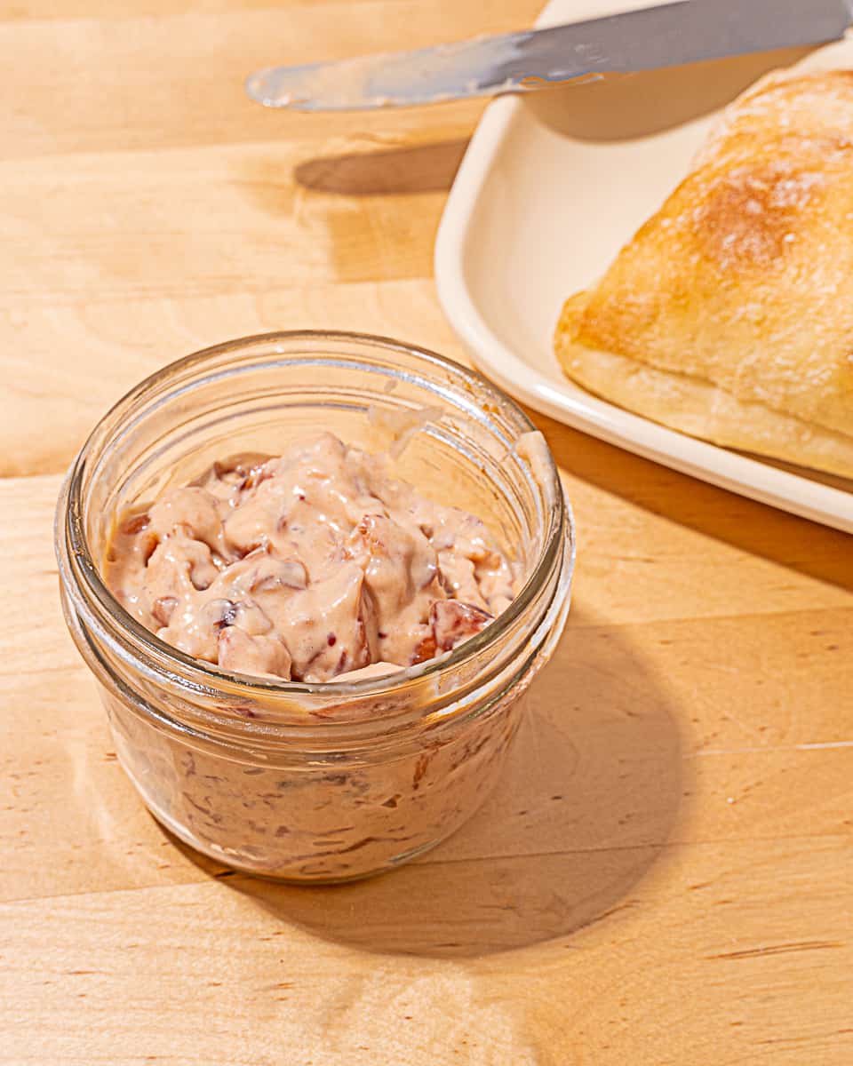 small glass bowl of pink cranberry mayonnaise