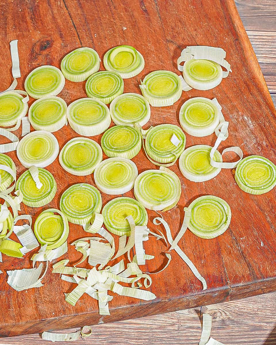 dehydrated leek rings on a red-brown wooden board