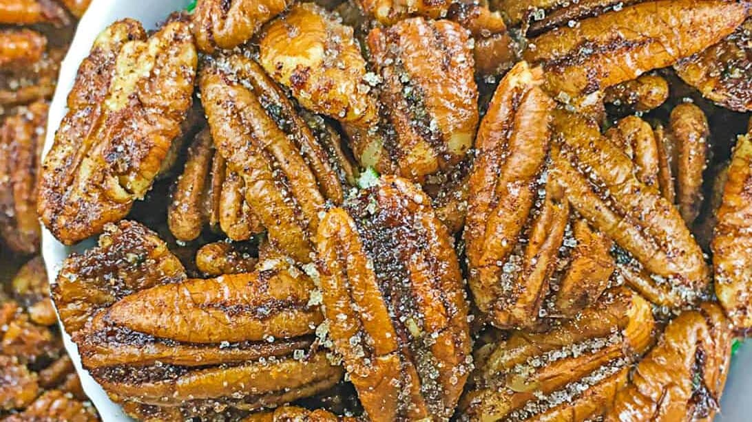 bowl of spicy candied pecans in a small bowl