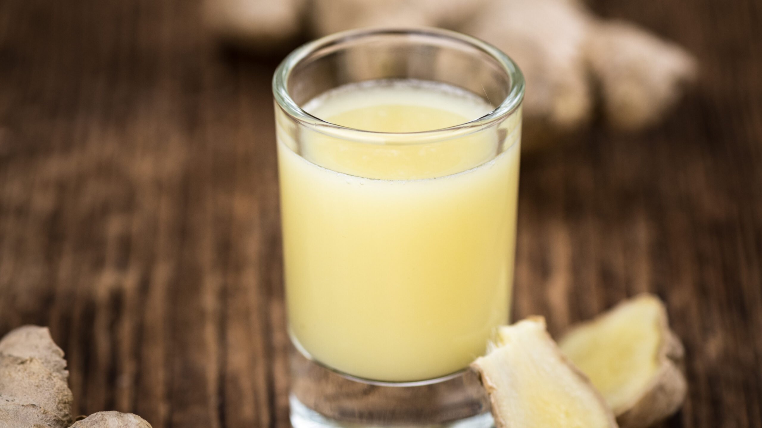 Ginger Drink in a shot glass on a wooden service