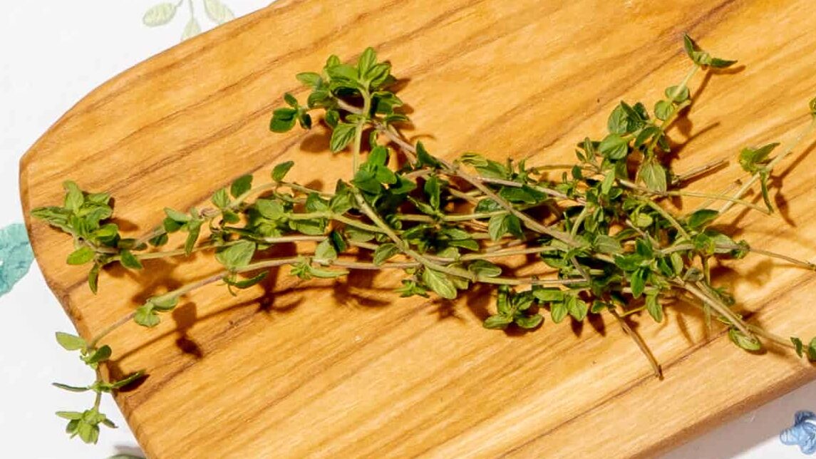 Thyme sprigs on a wooden board