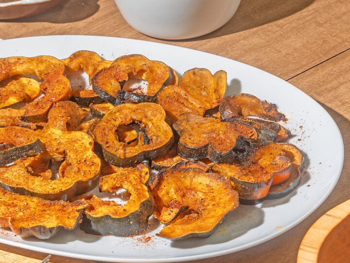 white plate of roasted acorn squash slices