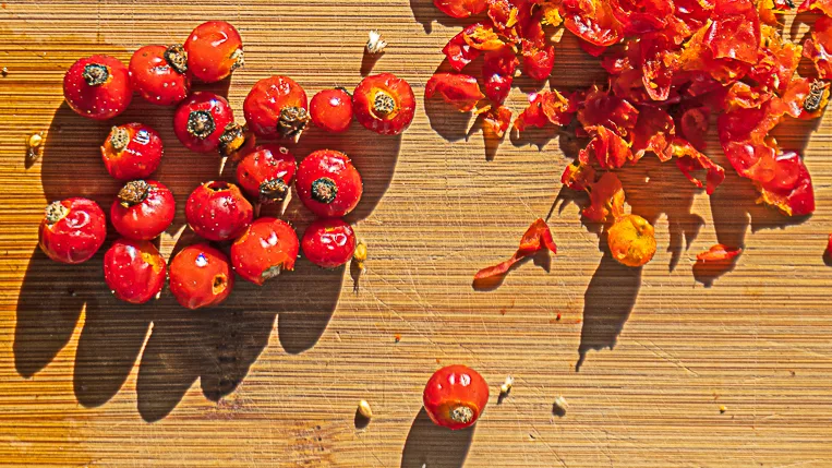 rose hips on a wooden board