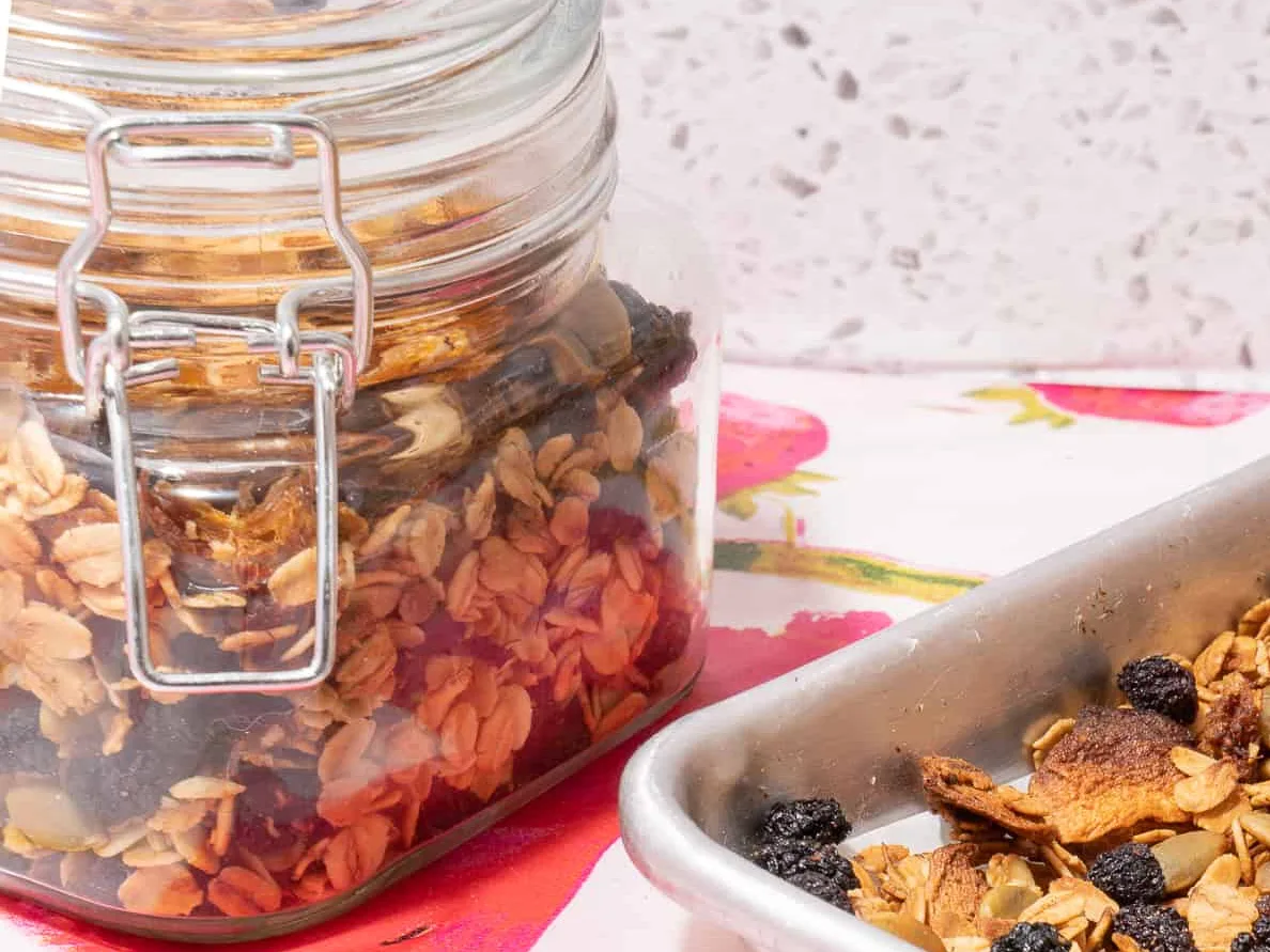 glass jar and sheet pan of granola 